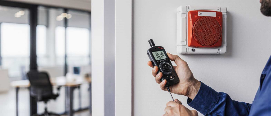 close-up_of_sound_level_meter_being_used_by_fire_safety_engineer_to_test_emergency_speaker_output_t_mnpoc77ecfv0xzc4ot1l_1.jpg